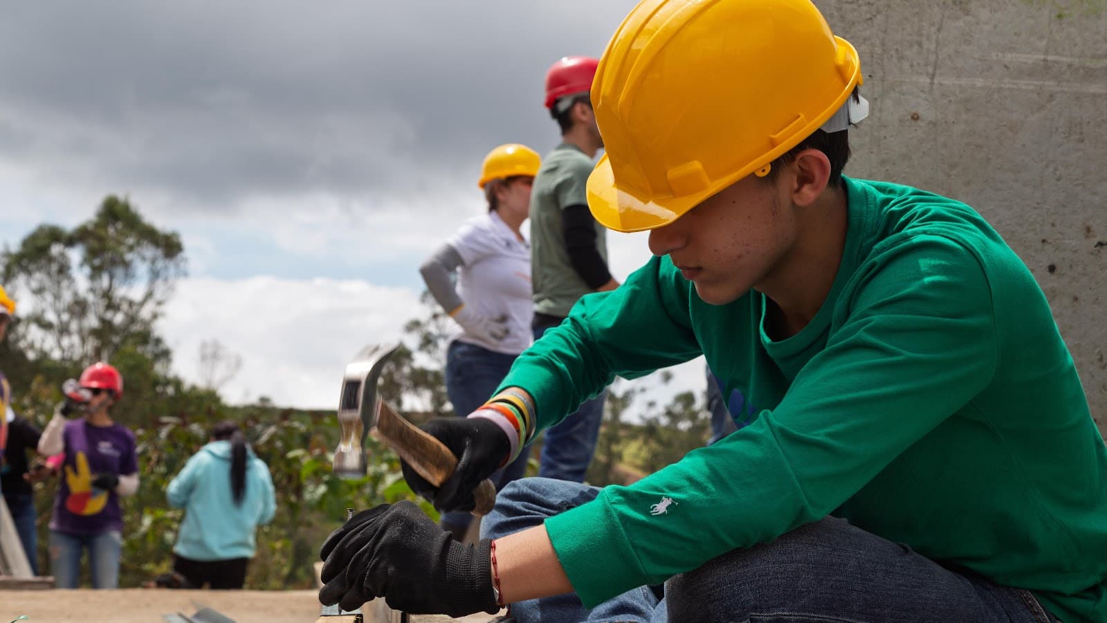 A volunteer hammering during construction of a home