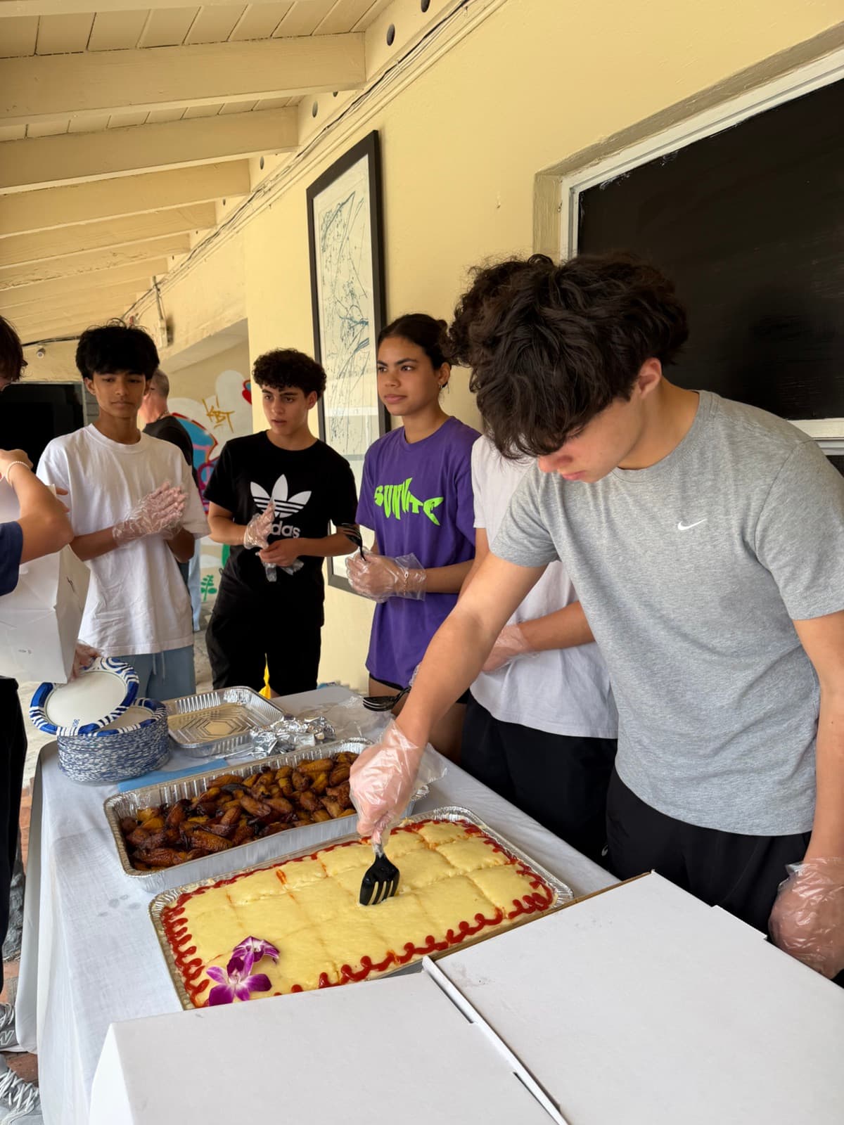 Volunteers serving food at a Manos for Homes community event in Miami